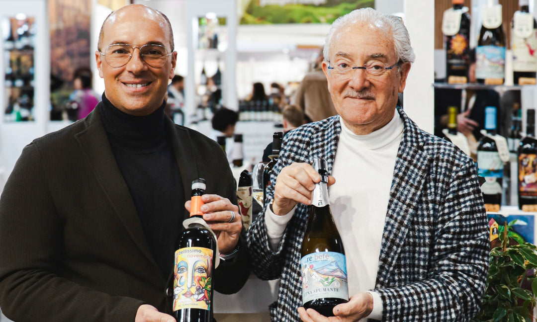 Two men proudly holding bottles of Etna wine, celebrating Etna wine excellence 2025.