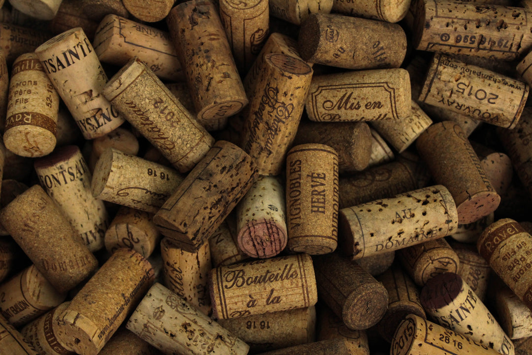 A selection of vintage wine corks showing various labels, highlighting the eco-friendly wine delivery experience.